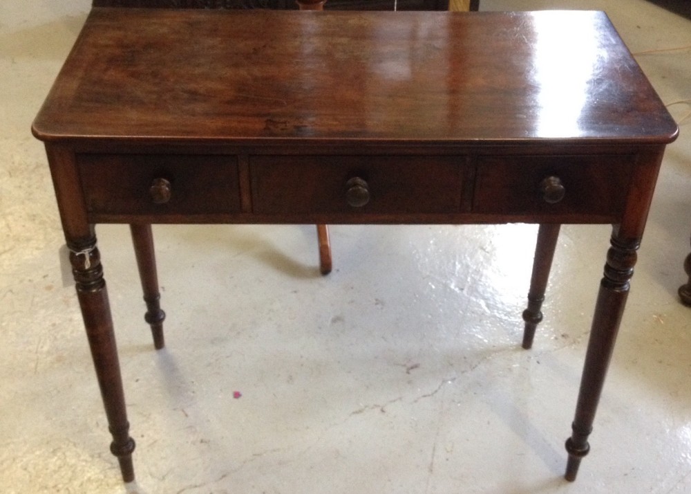 Late Georgian mahogany three drawer side table on turned legs
