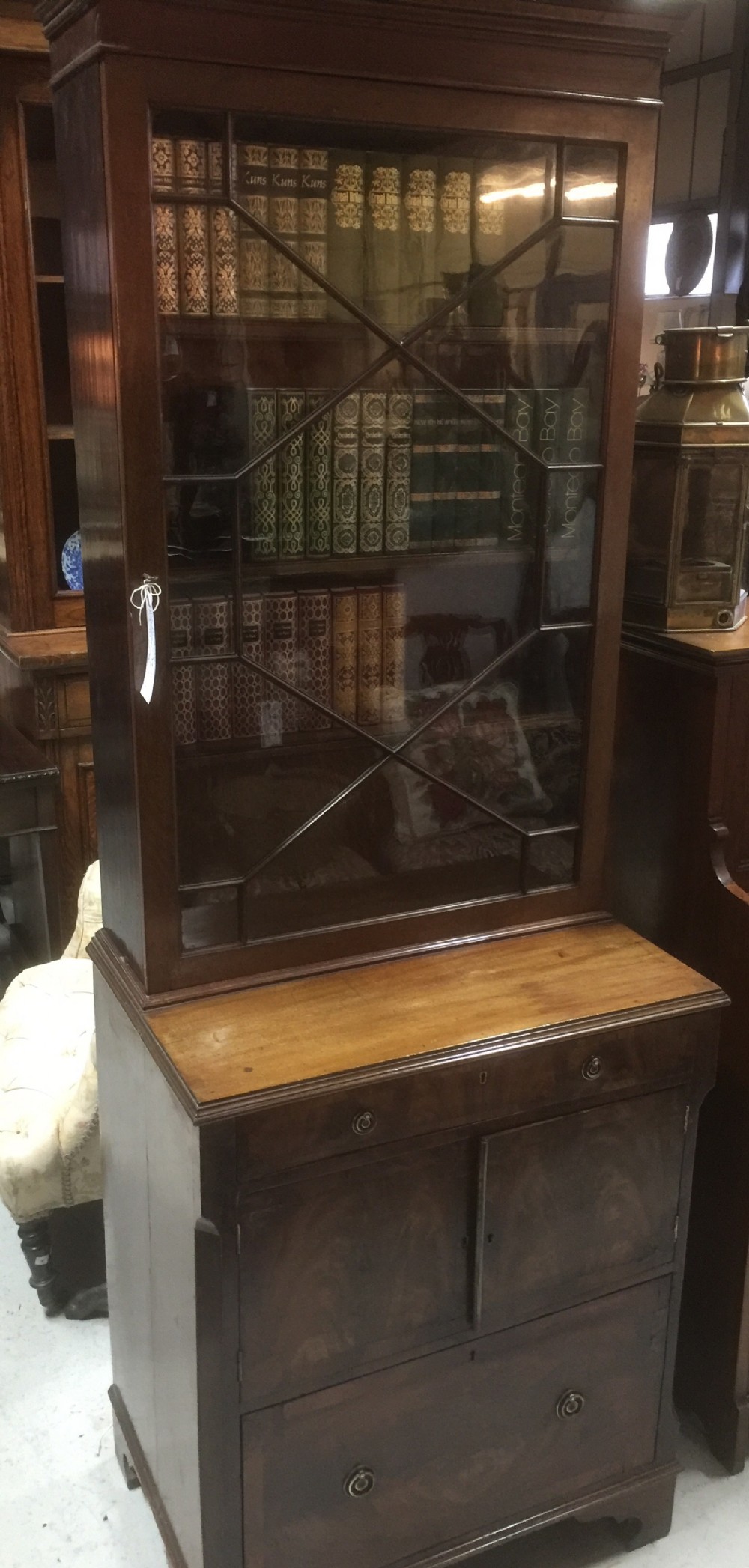 Narrow Victorian glazed mahogany bookcase over cupboard 