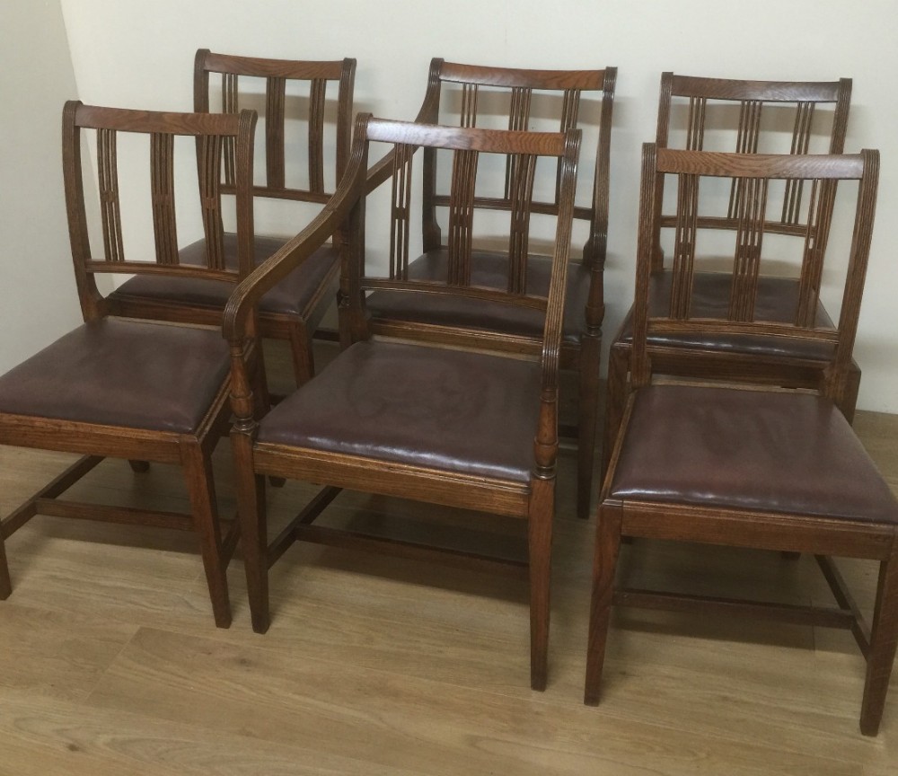 Arts and Crafts golden oak set of six dining chairs including two carvers 
