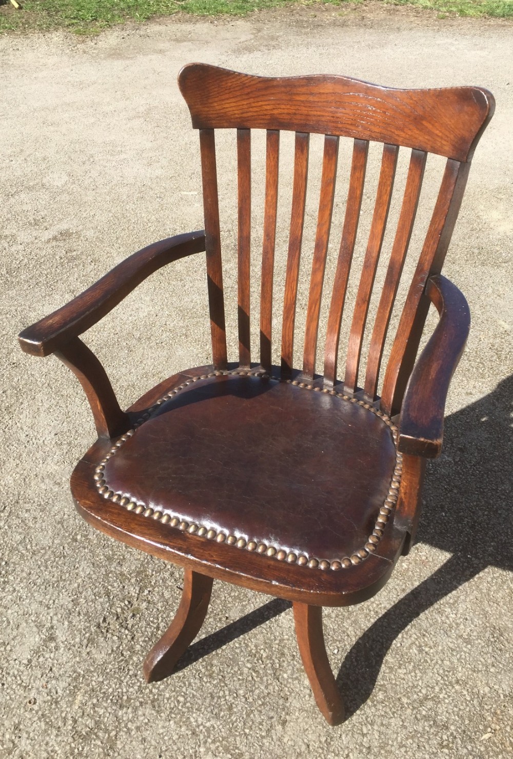 Edwardian oak desk chair Burgundy leather seat. 