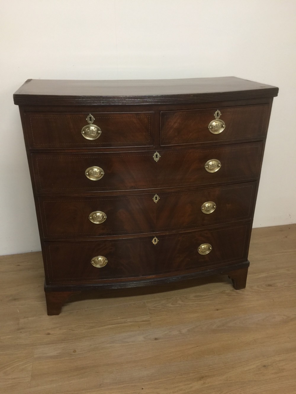 Late Georgian flame mahogany bow front chest of drawers 