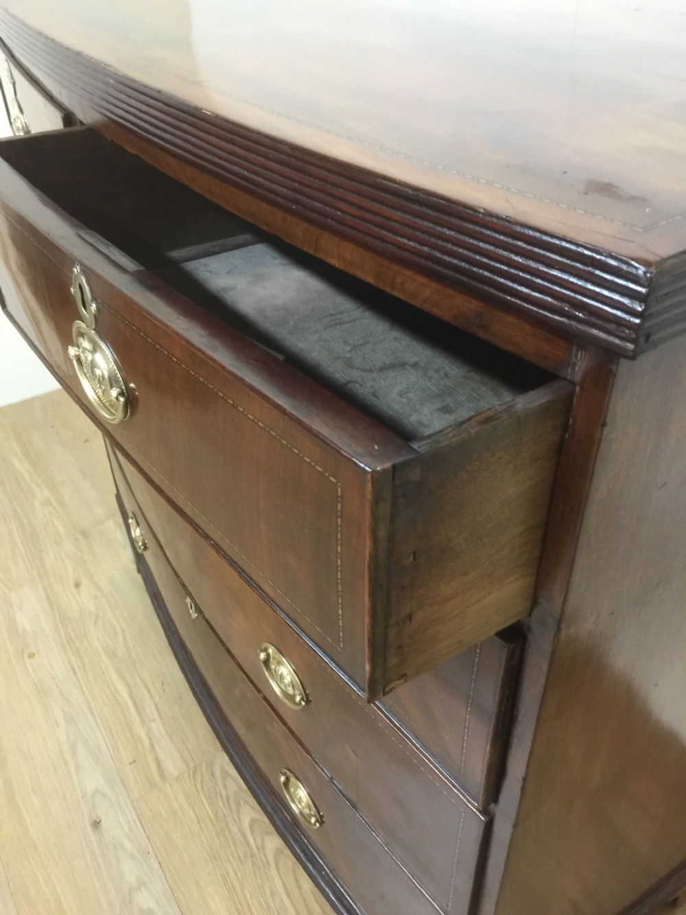 Late Georgian flame mahogany bow front chest of drawers  View XI