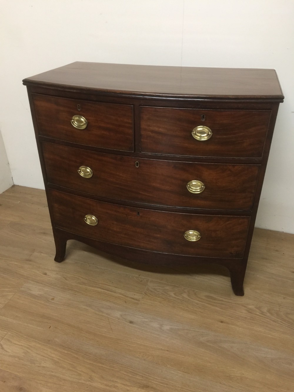Small Georgian flame mahogany bow front chest of drawers 