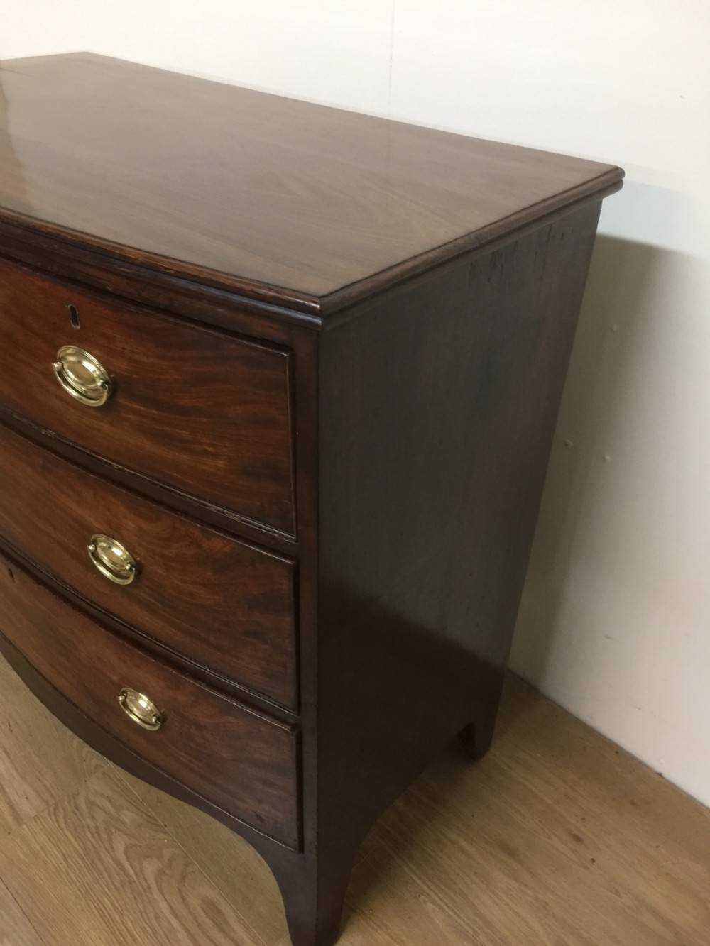 Small Georgian flame mahogany bow front chest of drawers  View II