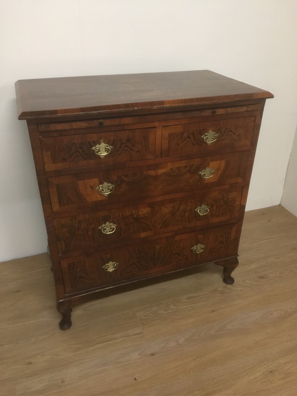 Nineteenth century crossbanded walnut chest of drawers with a dressing slide 