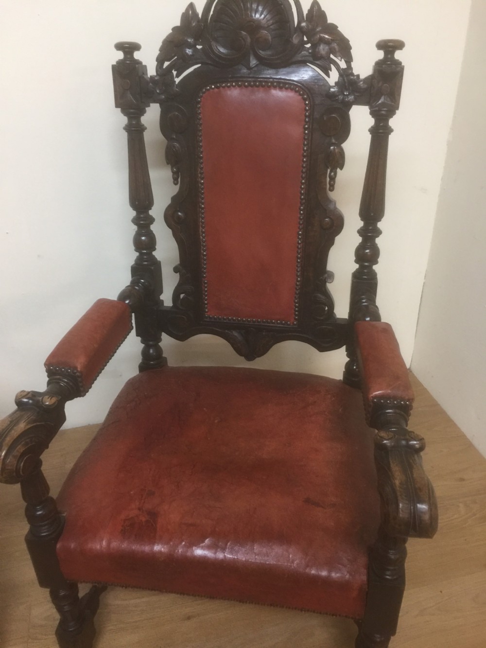 Pair of carved oak baronial chairs in original distressed leather View II