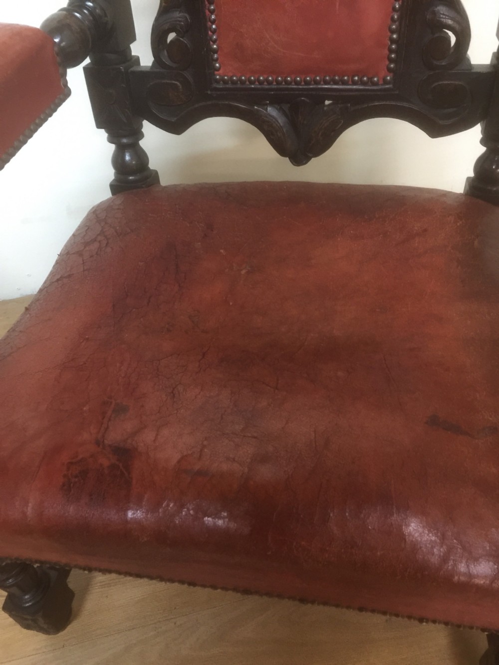 Pair of carved oak baronial chairs in original distressed leather View IV