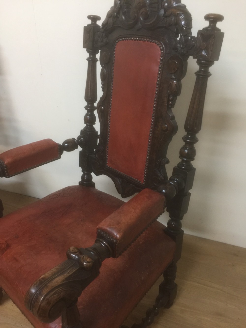 Pair of carved oak baronial chairs in original distressed leather View V