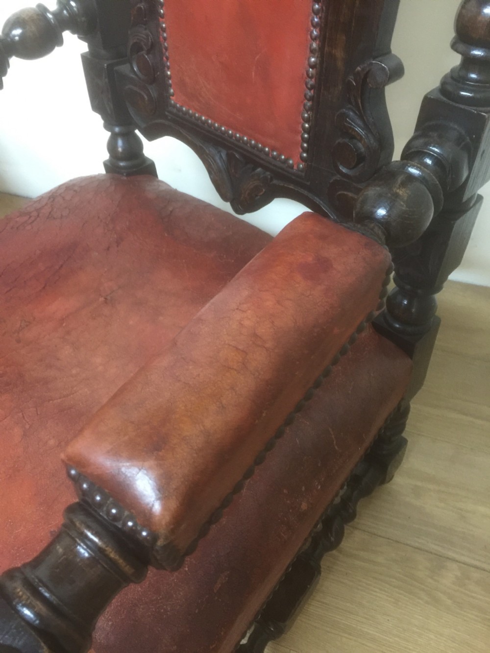 Pair of carved oak baronial chairs in original distressed leather View VII