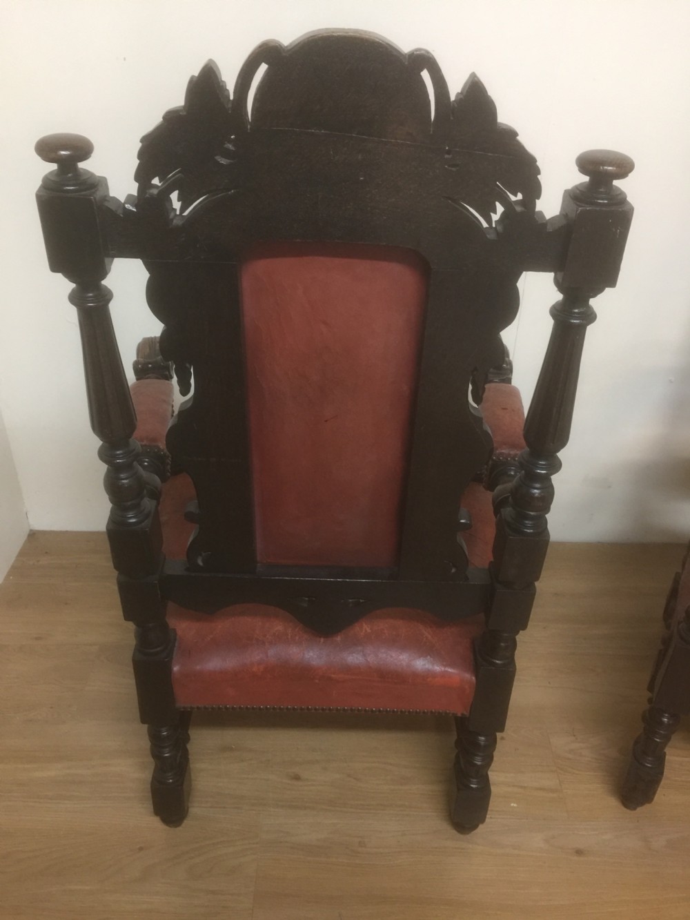 Pair of carved oak baronial chairs in original distressed leather View X
