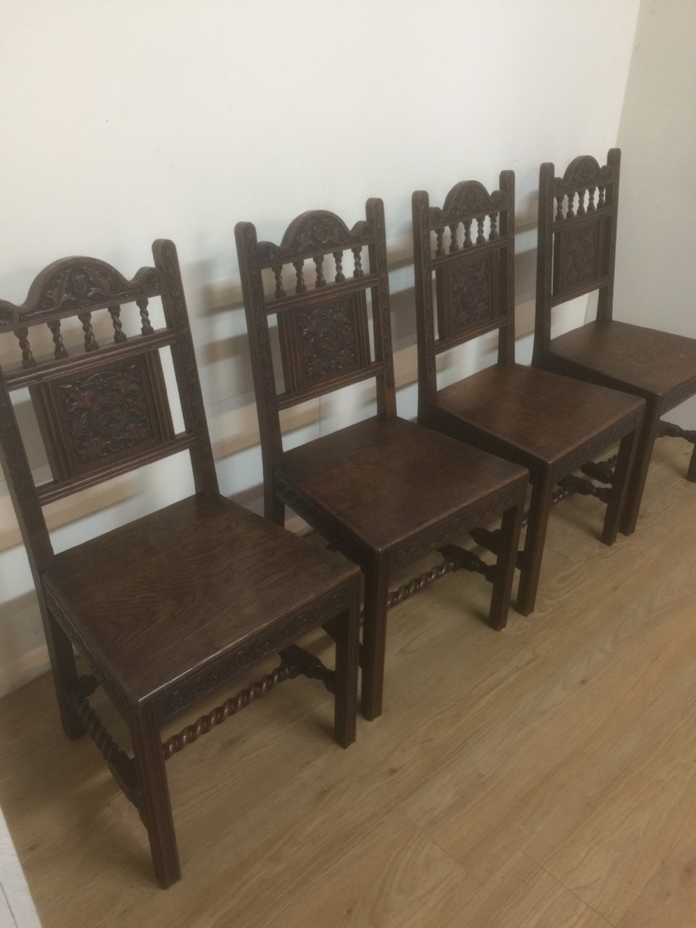 Four hand carved Edwardian oak chairs 