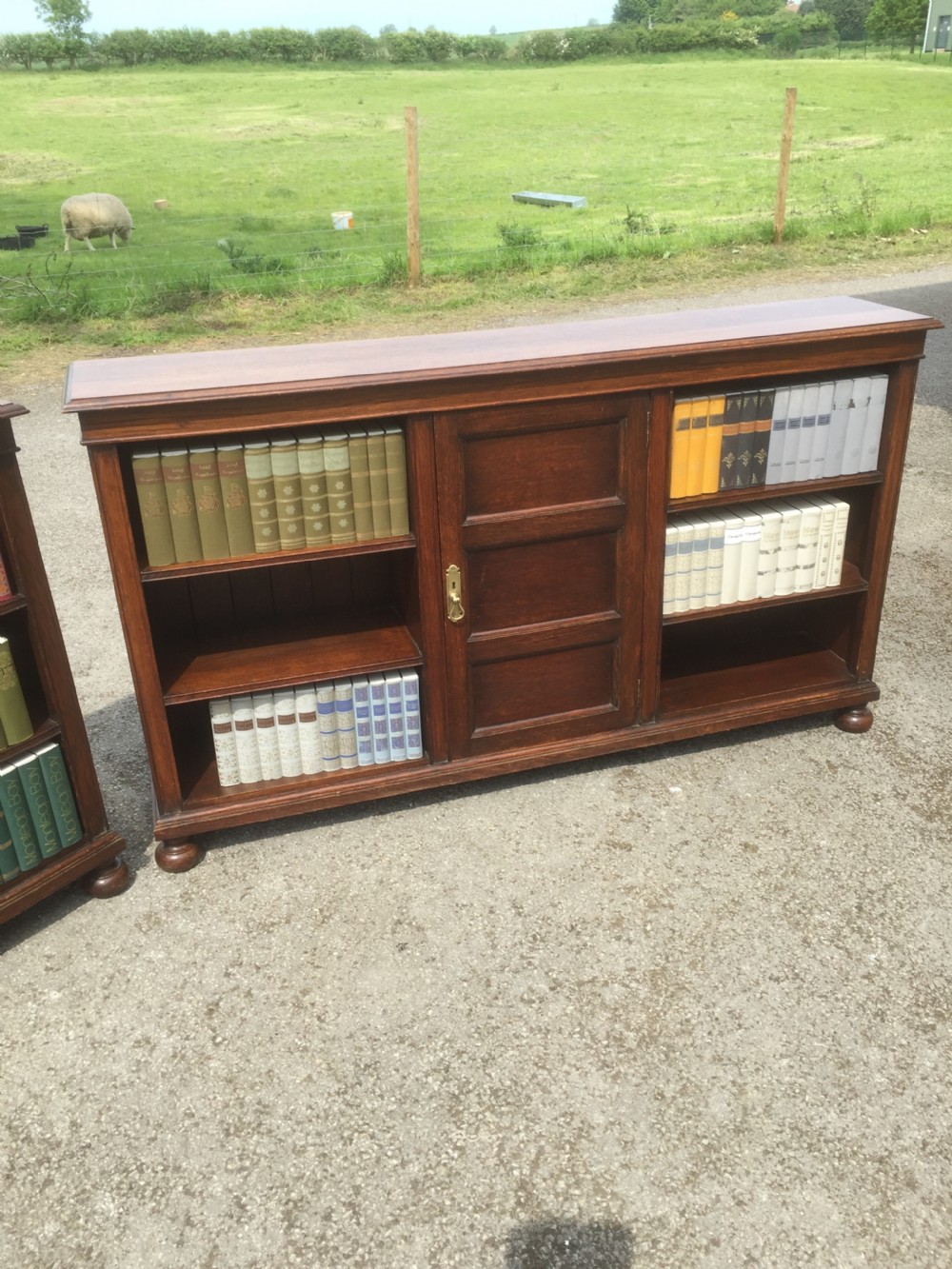 Pair of Waring and Gillow solid oak open bookcases circa 1920 View II