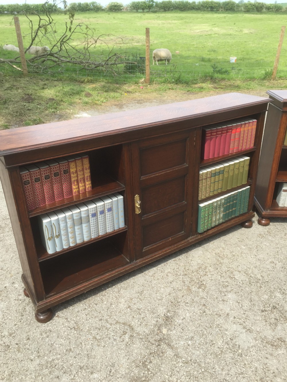 Pair of Waring and Gillow solid oak open bookcases circa 1920 View III
