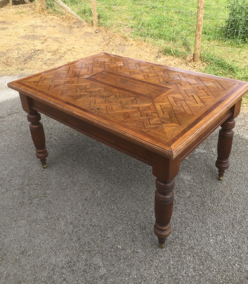 Nineteenth century oak parquetry six seater table on turned and reeded legs 