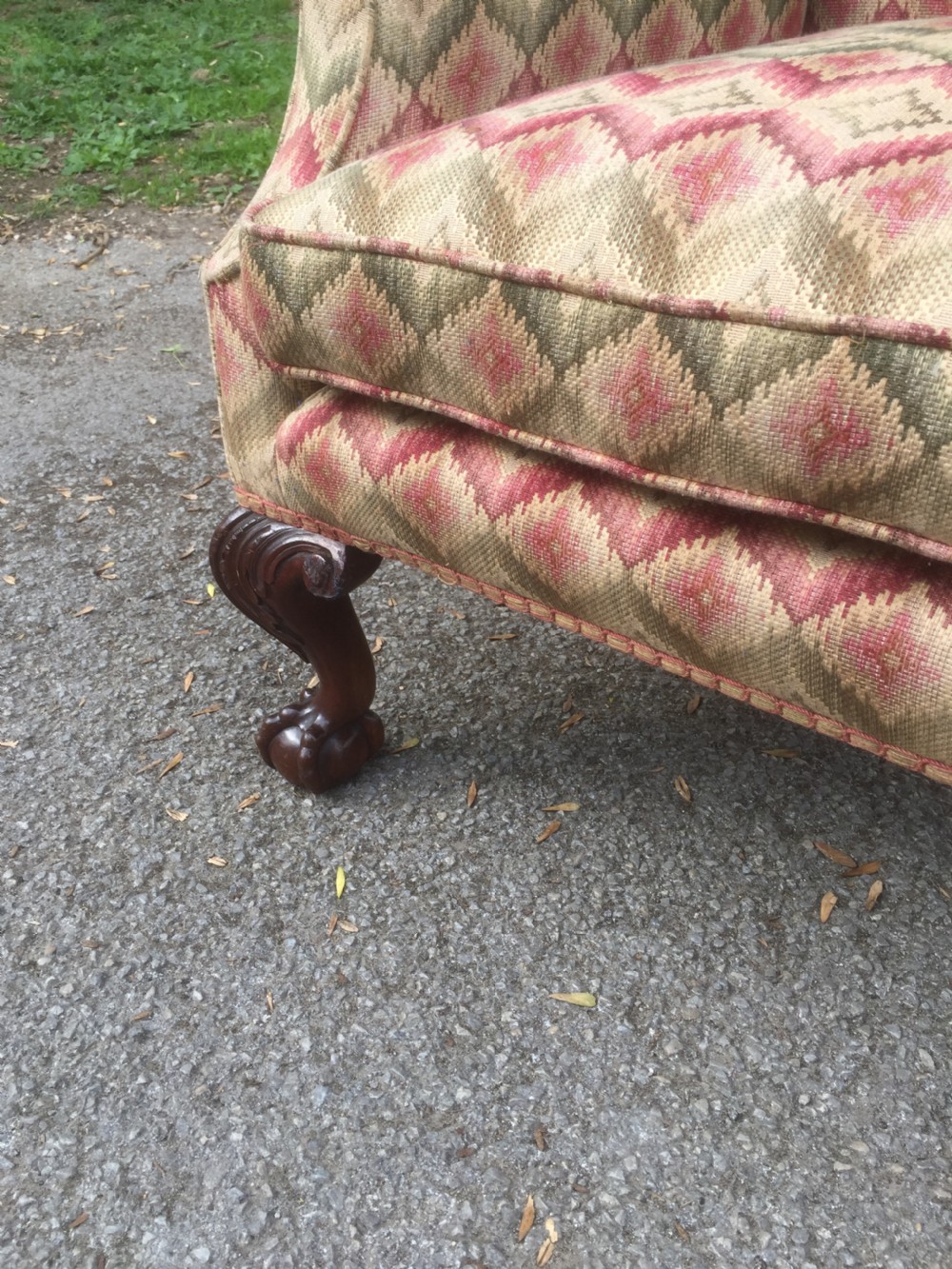 Edwardian traditionally upholstered winged armchair on carved ball and claw feet View III