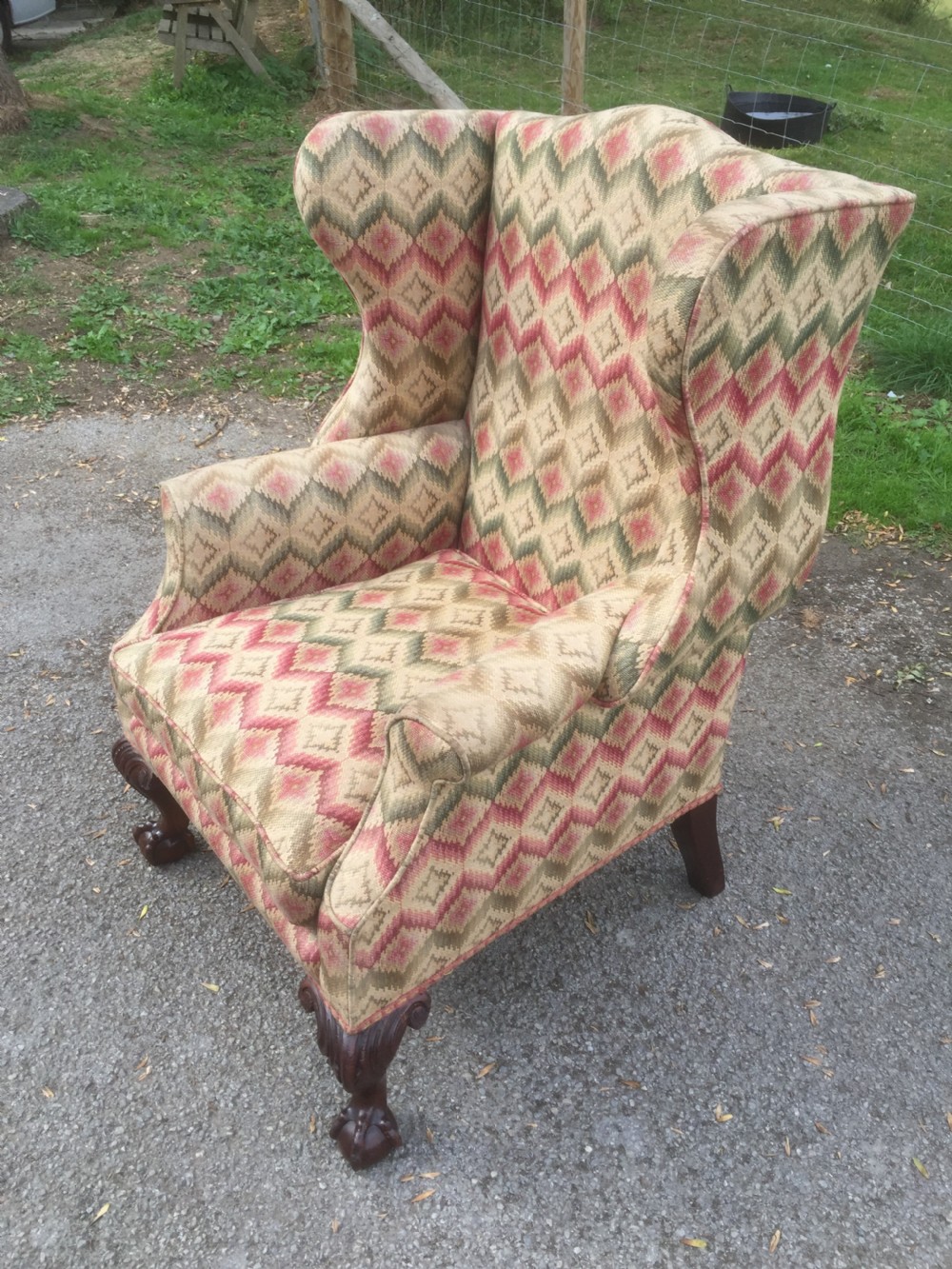 Edwardian traditionally upholstered winged armchair on carved ball and claw feet View IV
