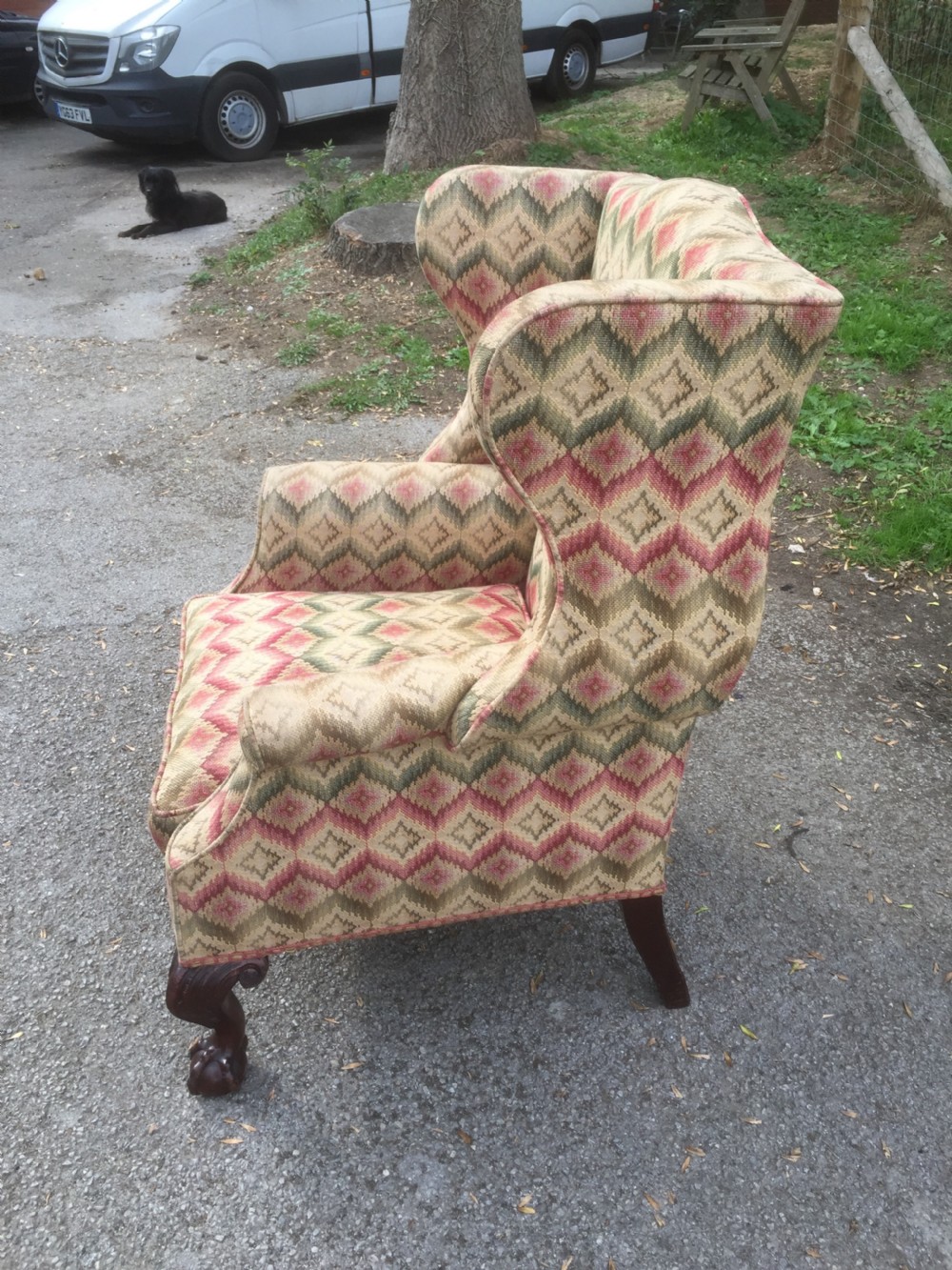 Edwardian traditionally upholstered winged armchair on carved ball and claw feet View V