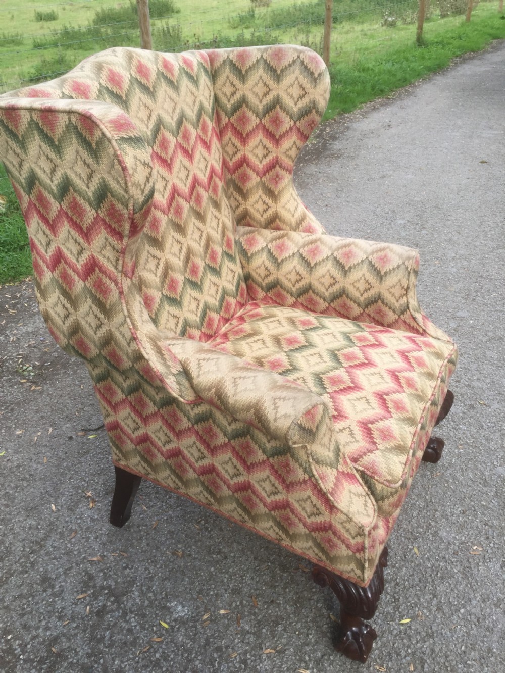 Edwardian traditionally upholstered winged armchair on carved ball and claw feet View VI