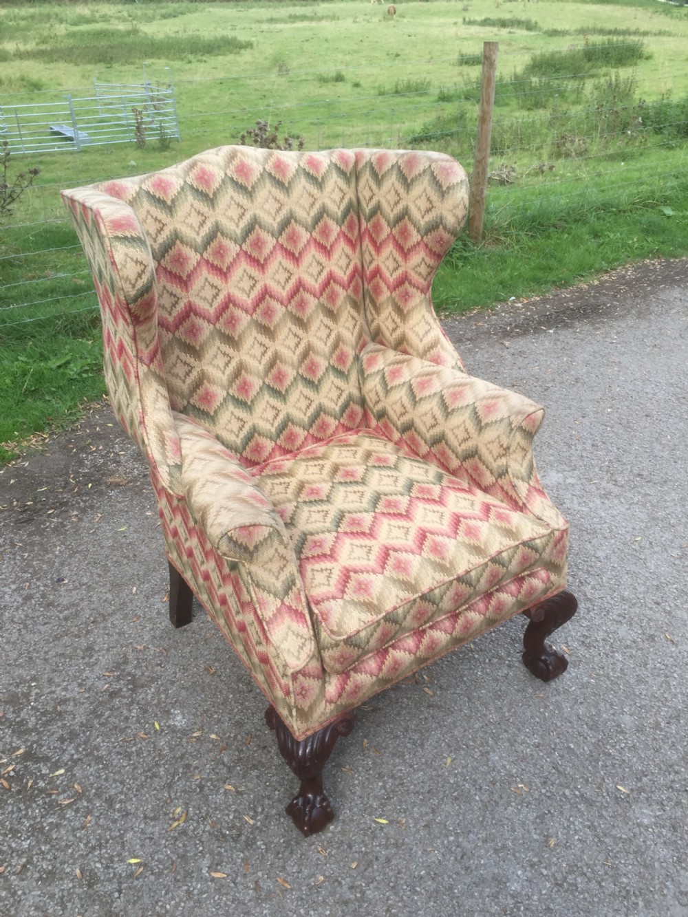 Edwardian traditionally upholstered winged armchair on carved ball and claw feet View VII
