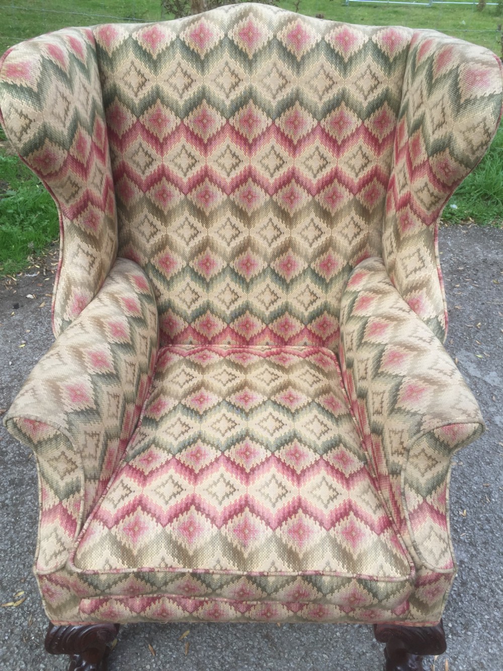 Edwardian traditionally upholstered winged armchair on carved ball and claw feet View IX