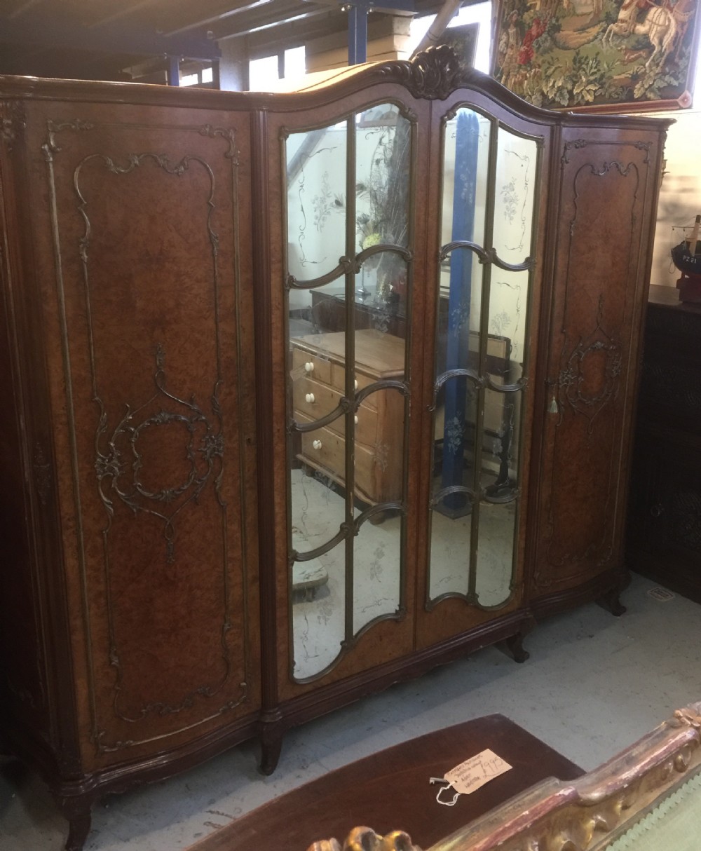 Four door burr walnut wardrobe with gilded carving circa 1920