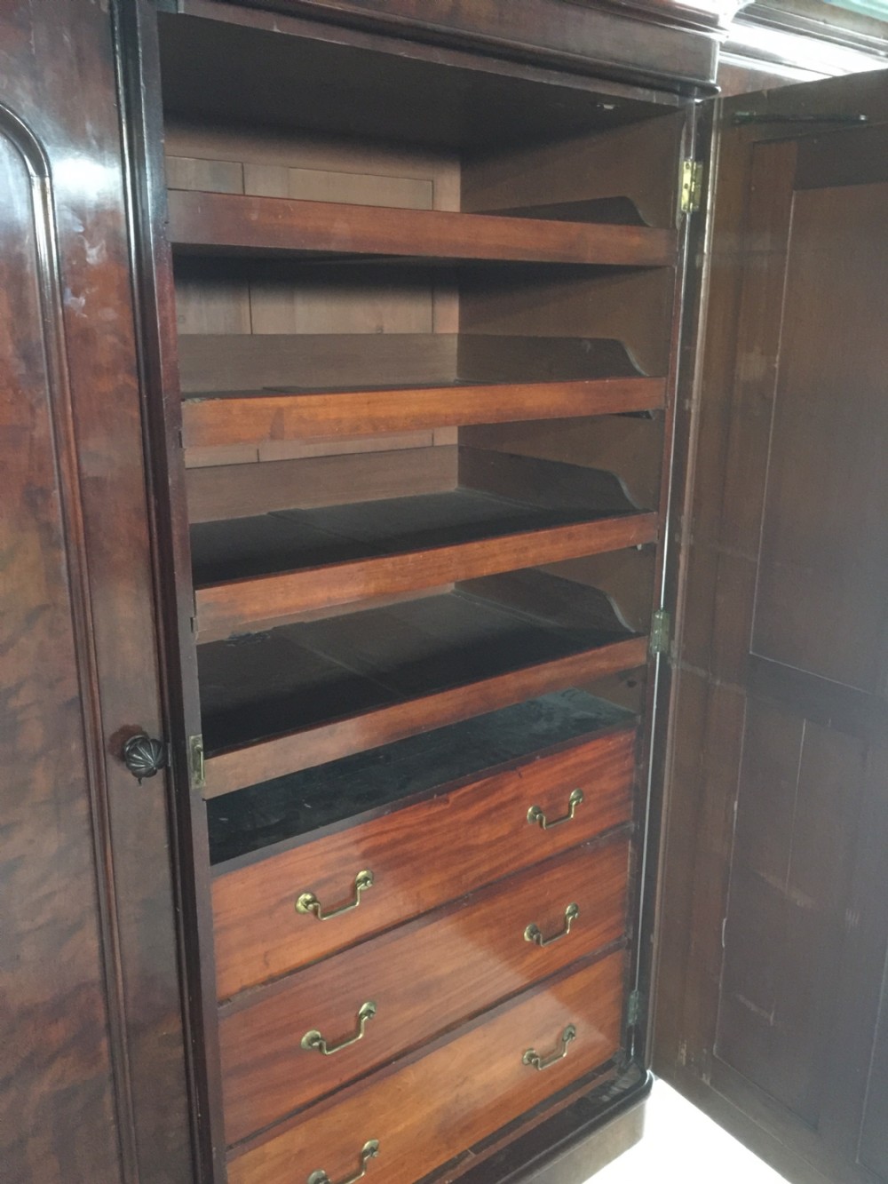 Nineteenth century flame mahogany triple wardrobe View X