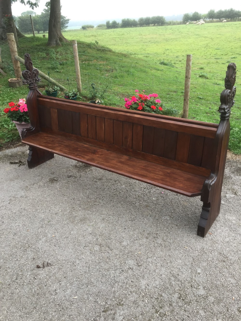 Nineteenth century pine pew with carved fleur de Lys finials  