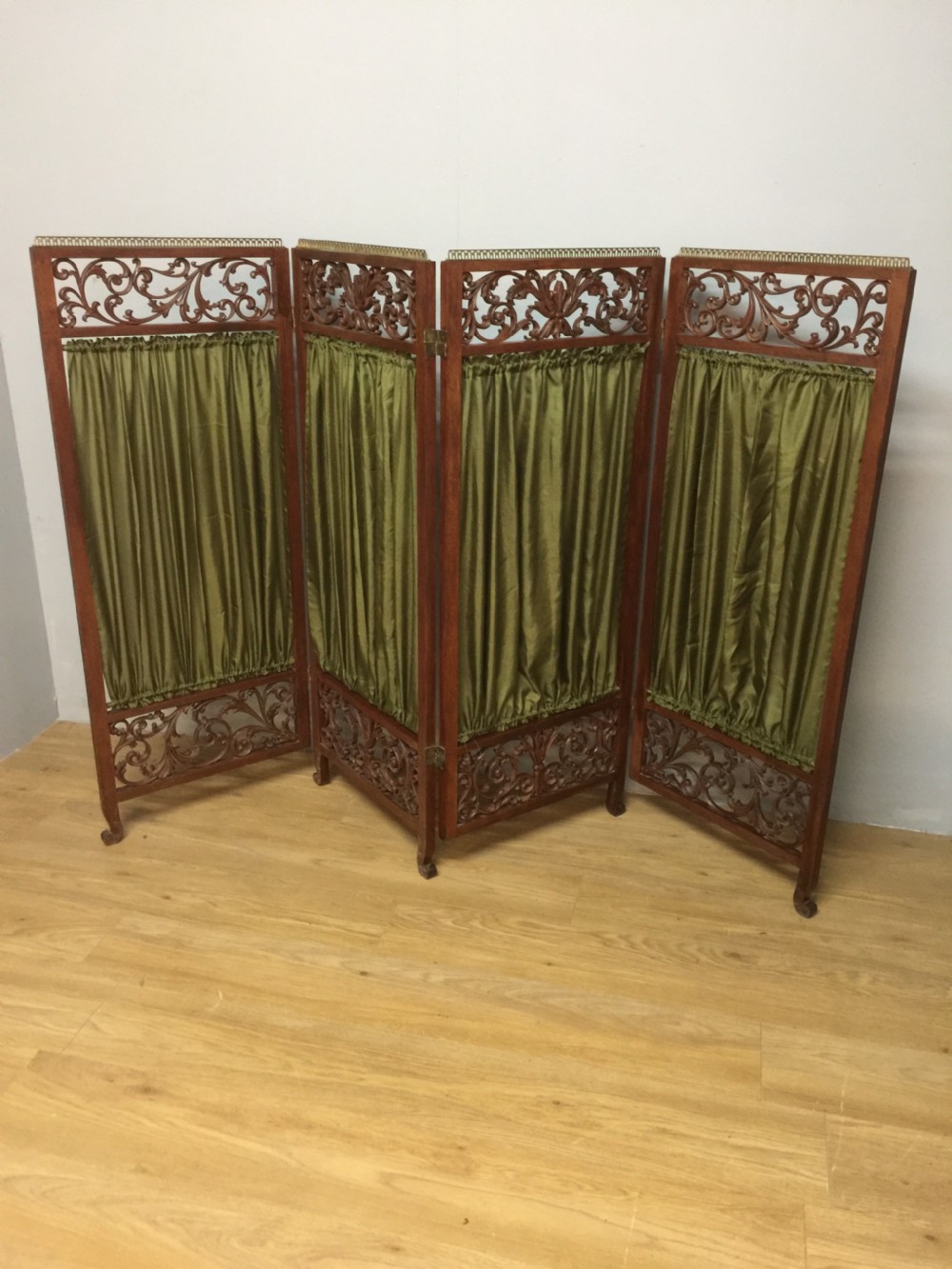 Late nineteenth century four panel screen with scrolling panels and brass gallery 