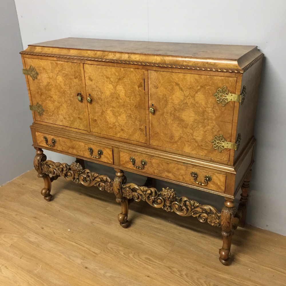 Burr walnut side cabinet on carved base