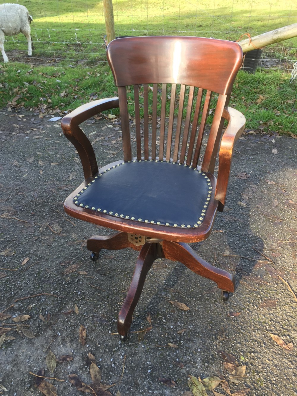 Slat back swivel office chair with leather seat  circa 1920 View II