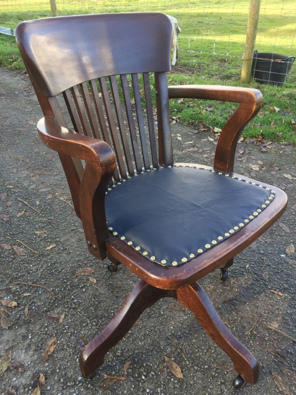 Slat back swivel office chair with leather seat  circa 1920 View X
