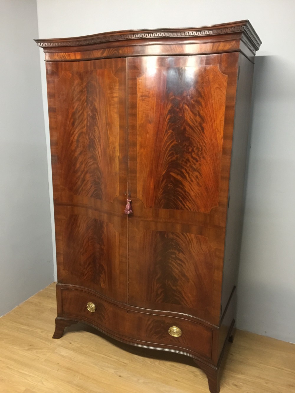 Edwardian Sheraton style serpentine fronted flame mahogany wardrobe 