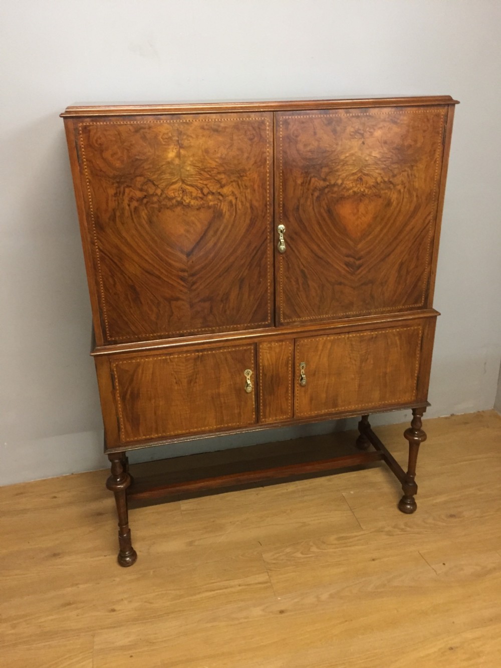 Inlaid burr walnut side cabinet on turned supports circa 1920 View II