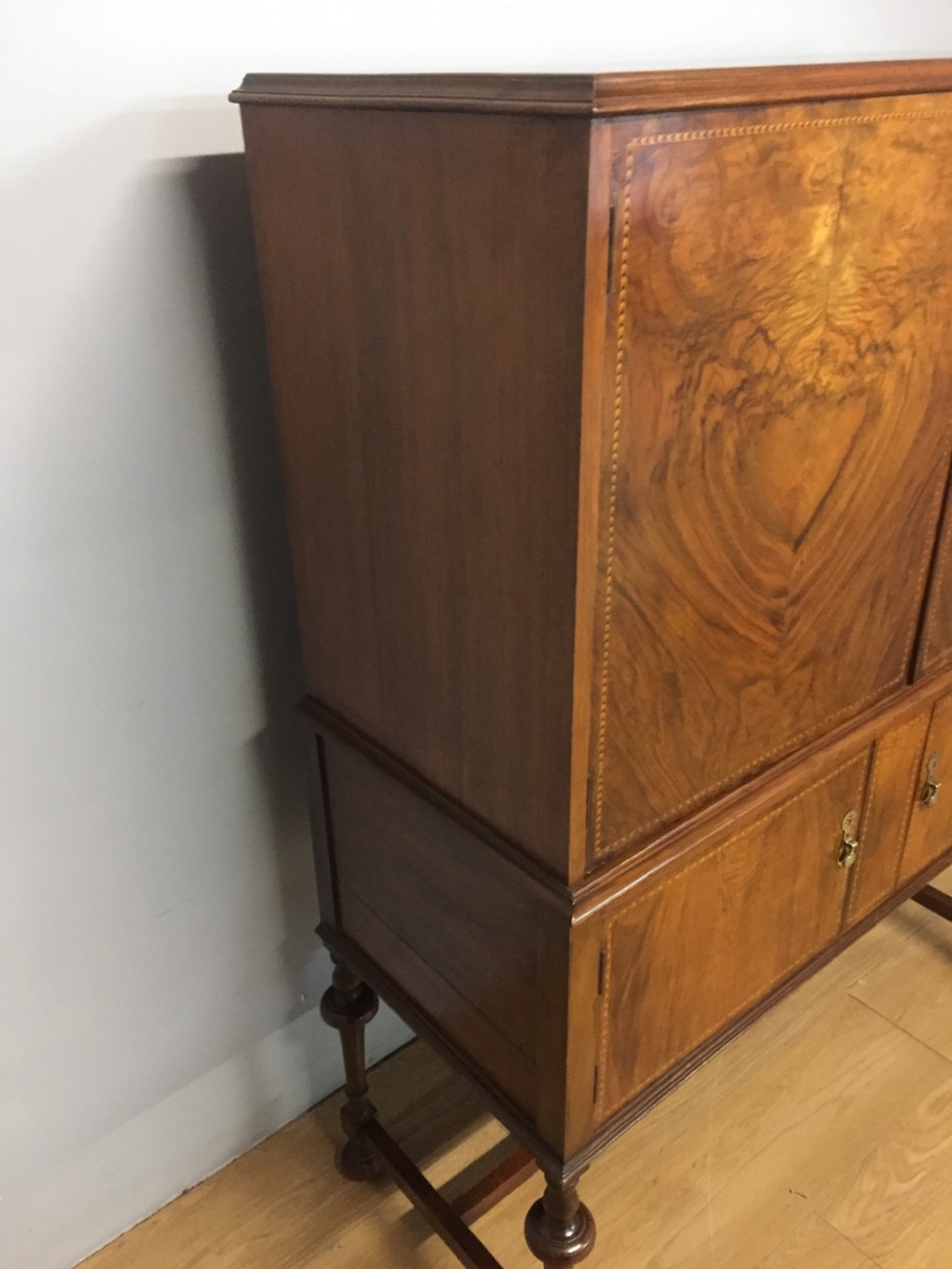 Inlaid burr walnut side cabinet on turned supports circa 1920 View III