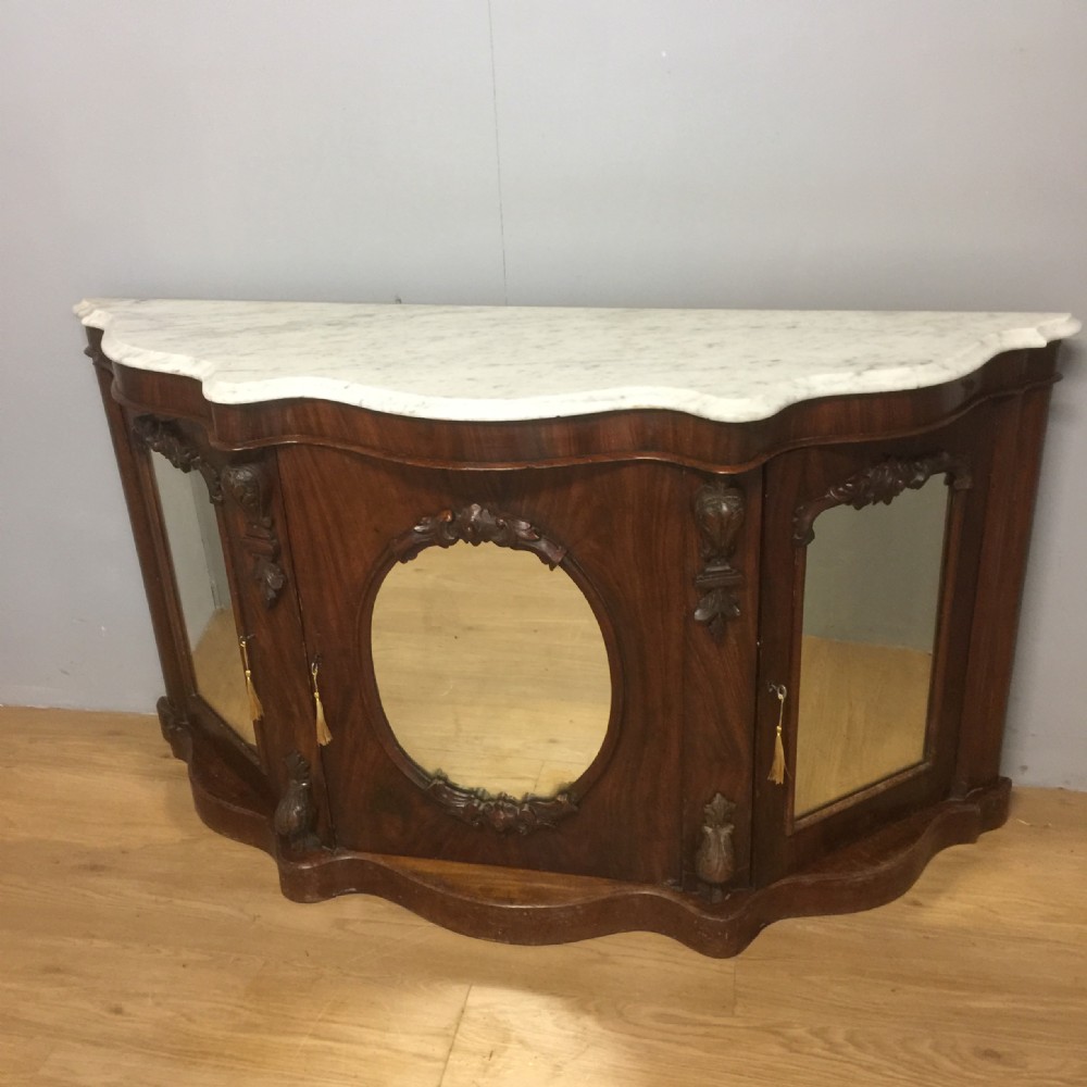 Nineteenth century serpentine flame mahogany marble topped credenza