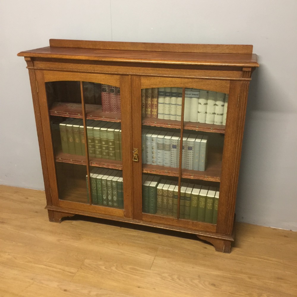 Arts and Crafts solid oak freestanding glazed bookcase