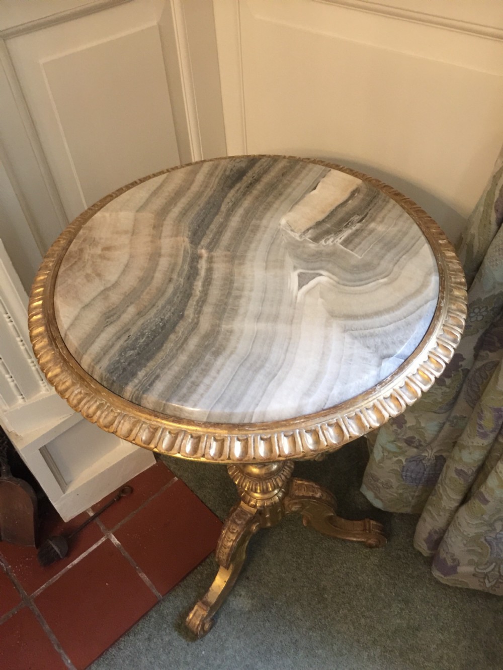 A 19th-century tripod table featuring a carved giltwood pedestal base, egg-and-dart moulding, and a circular variegated grey marble tabletop. View II