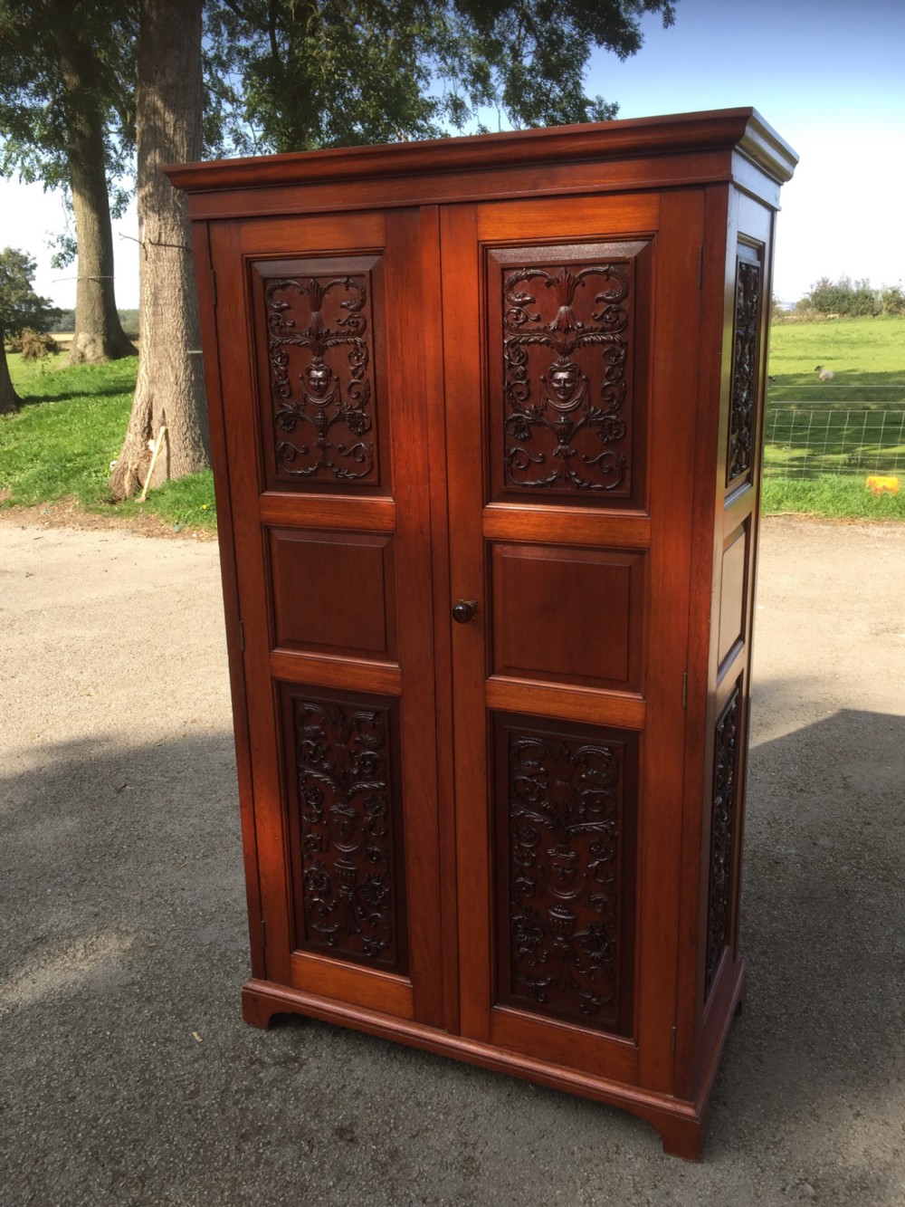 Arts and Crafts walnut hall cupboard with carved panels  View II