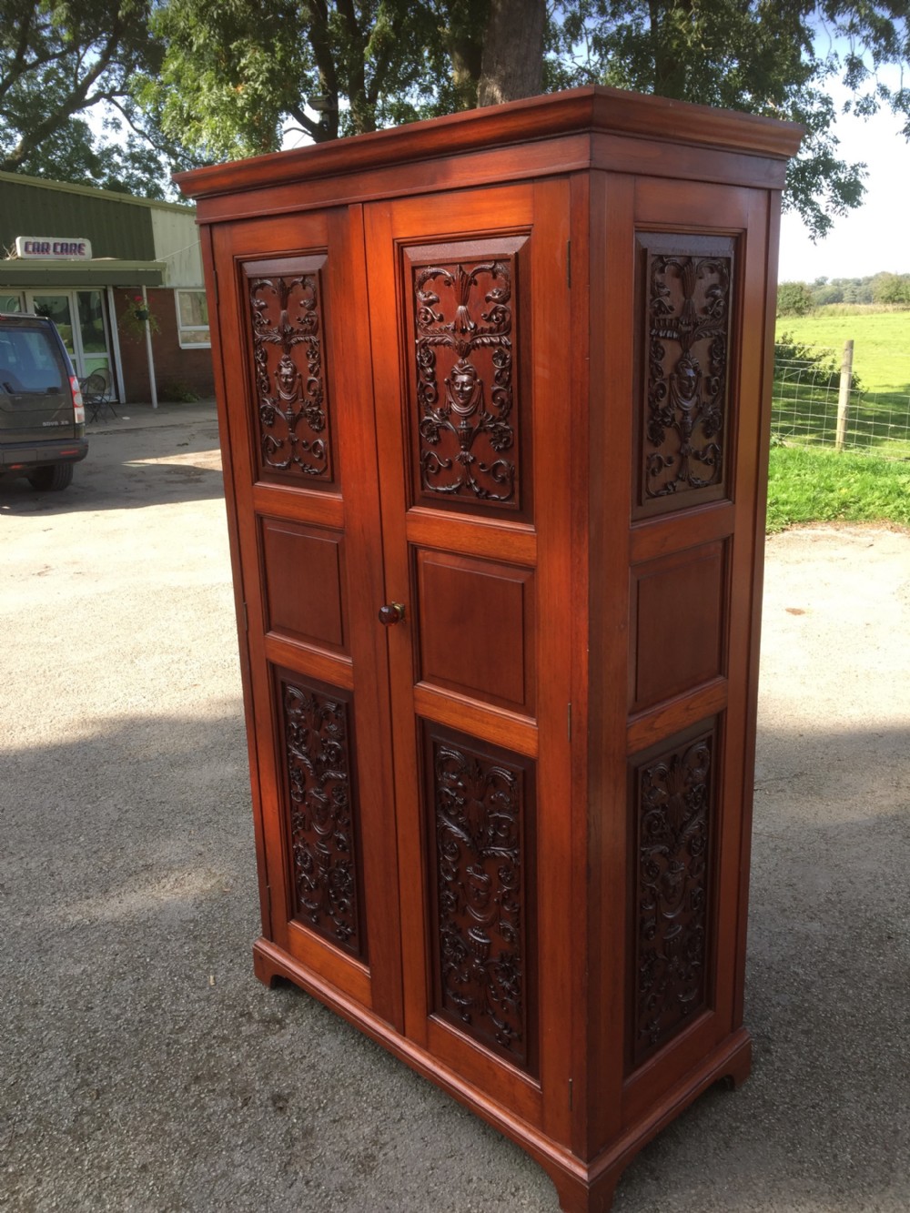 Arts and Crafts walnut hall cupboard with carved panels  View IV