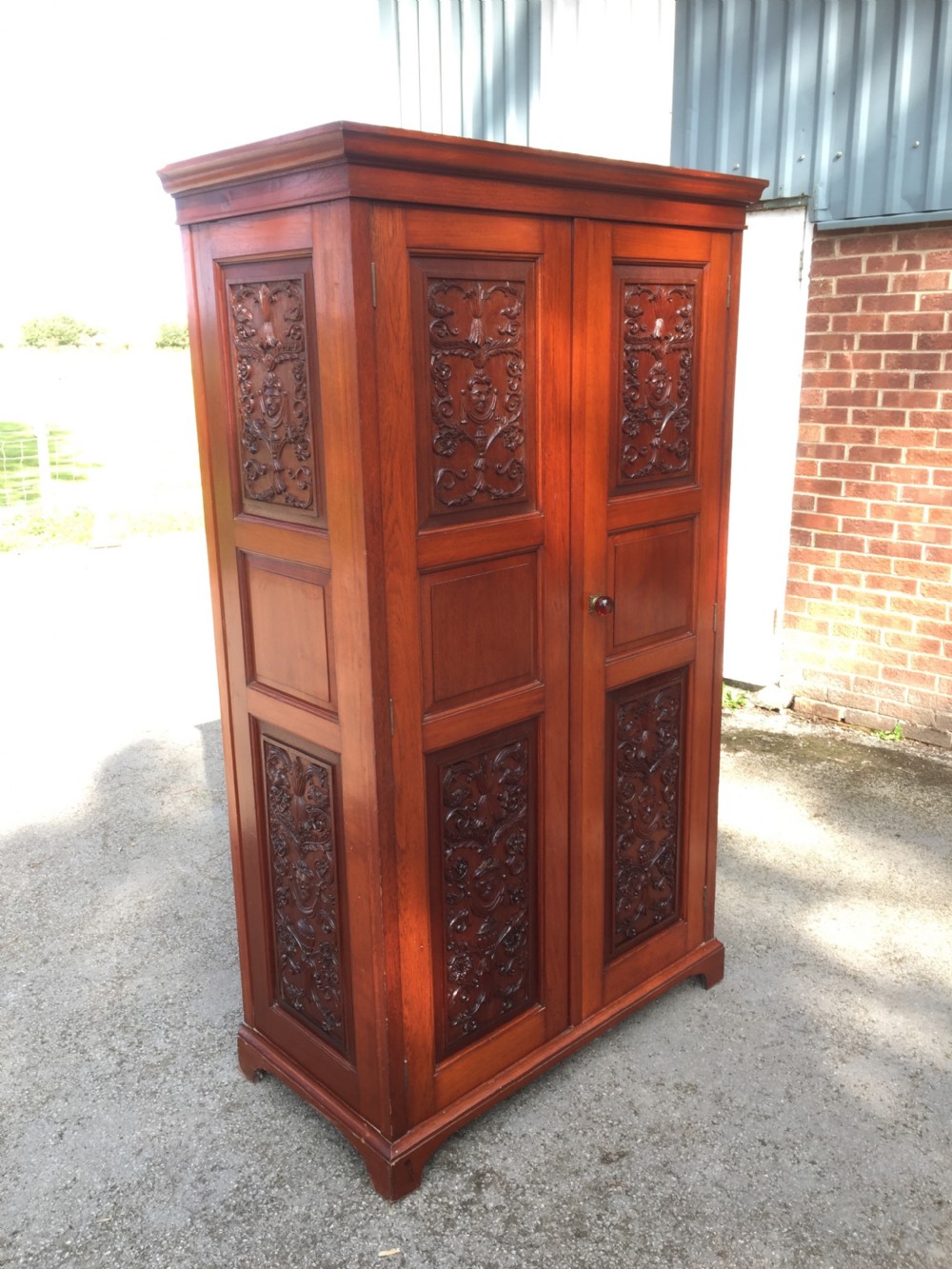 Arts and Crafts walnut hall cupboard with carved panels  View V
