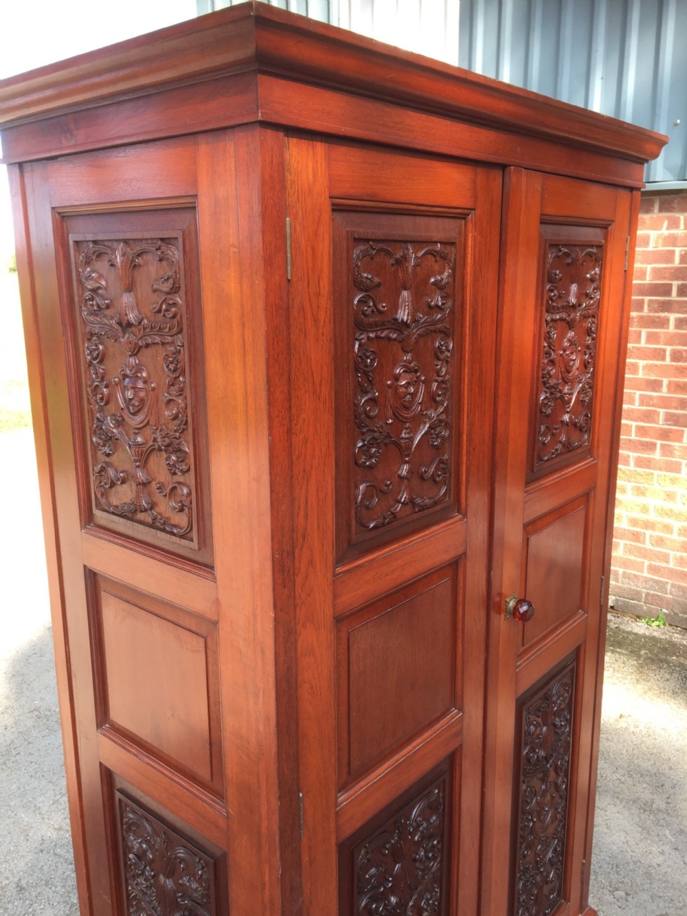 Arts and Crafts walnut hall cupboard with carved panels  View XI