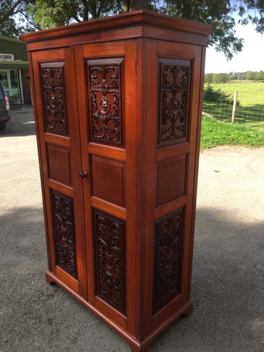 Arts and Crafts walnut hall cupboard with carved panels  View XII