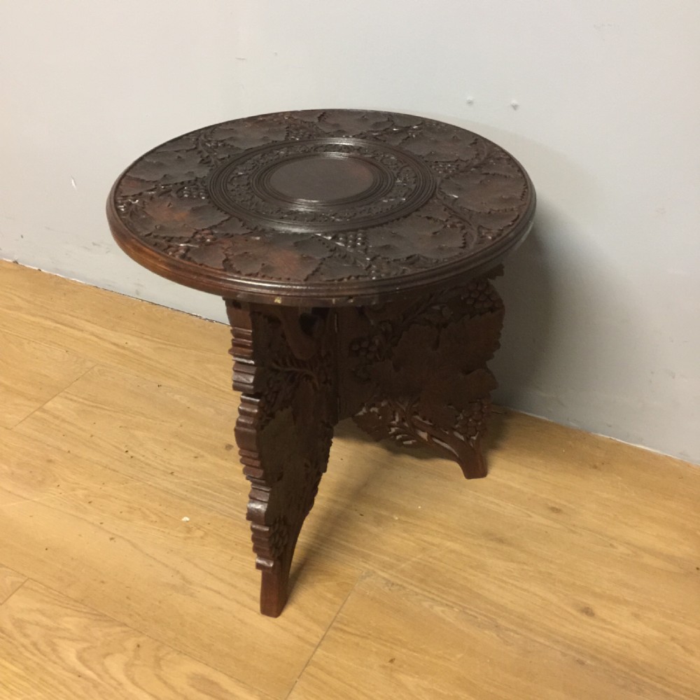 Carved circular wine table on tripod base 