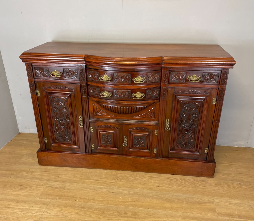 Late nineteenth century carved walnut bow fronted sideboard 