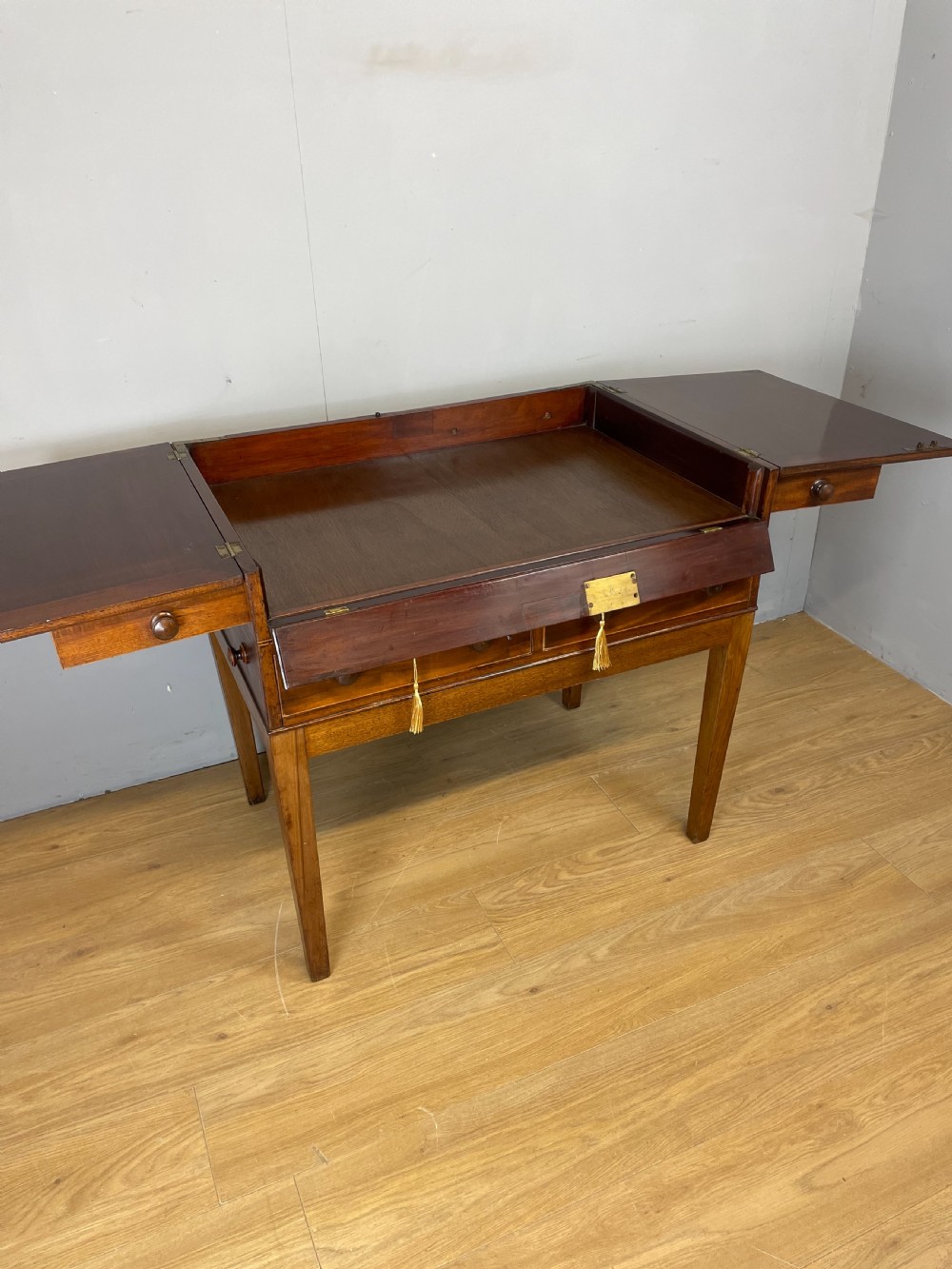 A Late Georgian inlaid mahogany collectors cabinet with square tapered legs, brass keyhole escutcheons, side knobs, and multiple drawers. View III