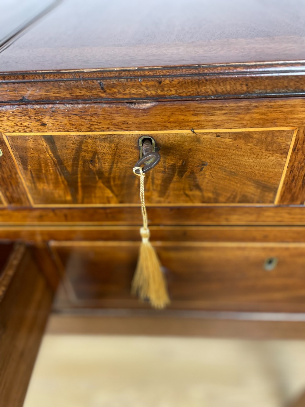 A Late Georgian inlaid mahogany collectors cabinet with square tapered legs, brass keyhole escutcheons, side knobs, and multiple drawers. View VI