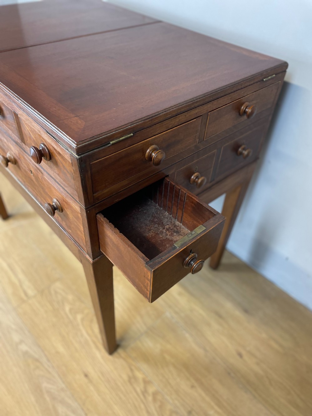 A Late Georgian inlaid mahogany collectors cabinet with square tapered legs, brass keyhole escutcheons, side knobs, and multiple drawers. View IX