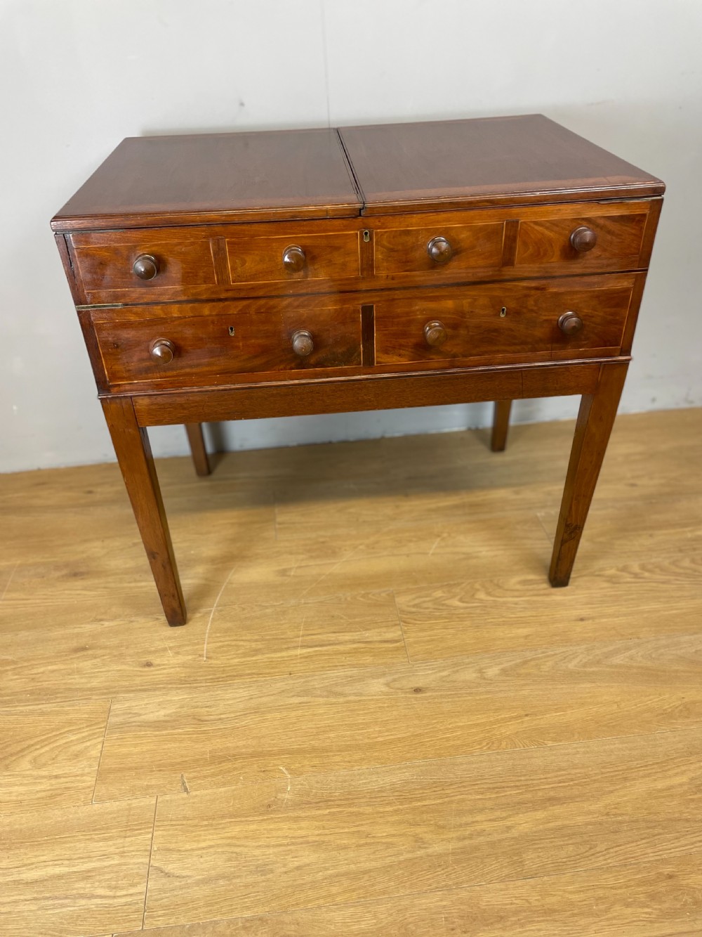 A Late Georgian inlaid mahogany collectors cabinet with square tapered legs, brass keyhole escutcheons, side knobs, and multiple drawers. View XI