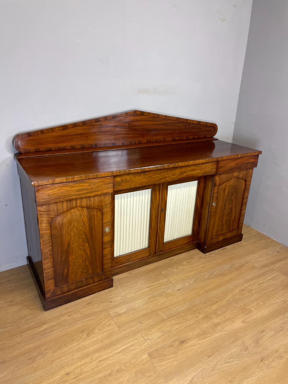 Late Georgian flame mahogany four door sideboard 