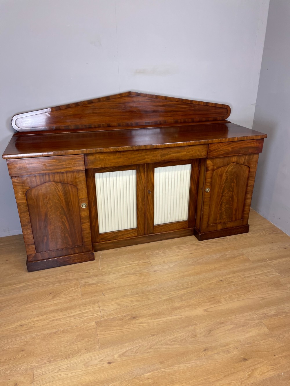 Late Georgian flame mahogany four door sideboard  View II